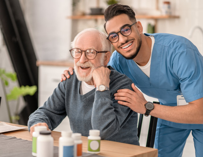 male nurse and elderly man smiling