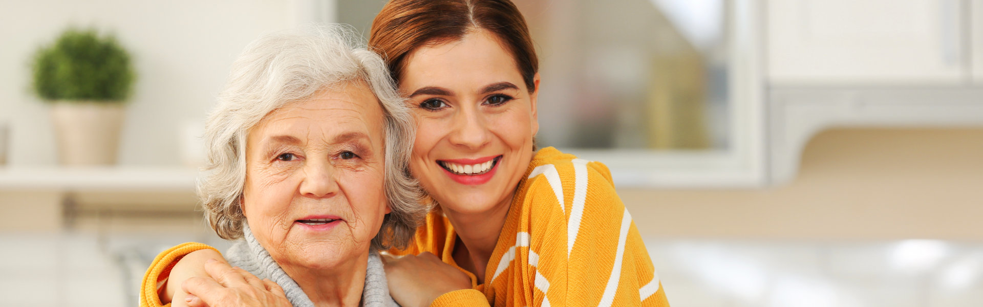 elderly woman and woman smiling